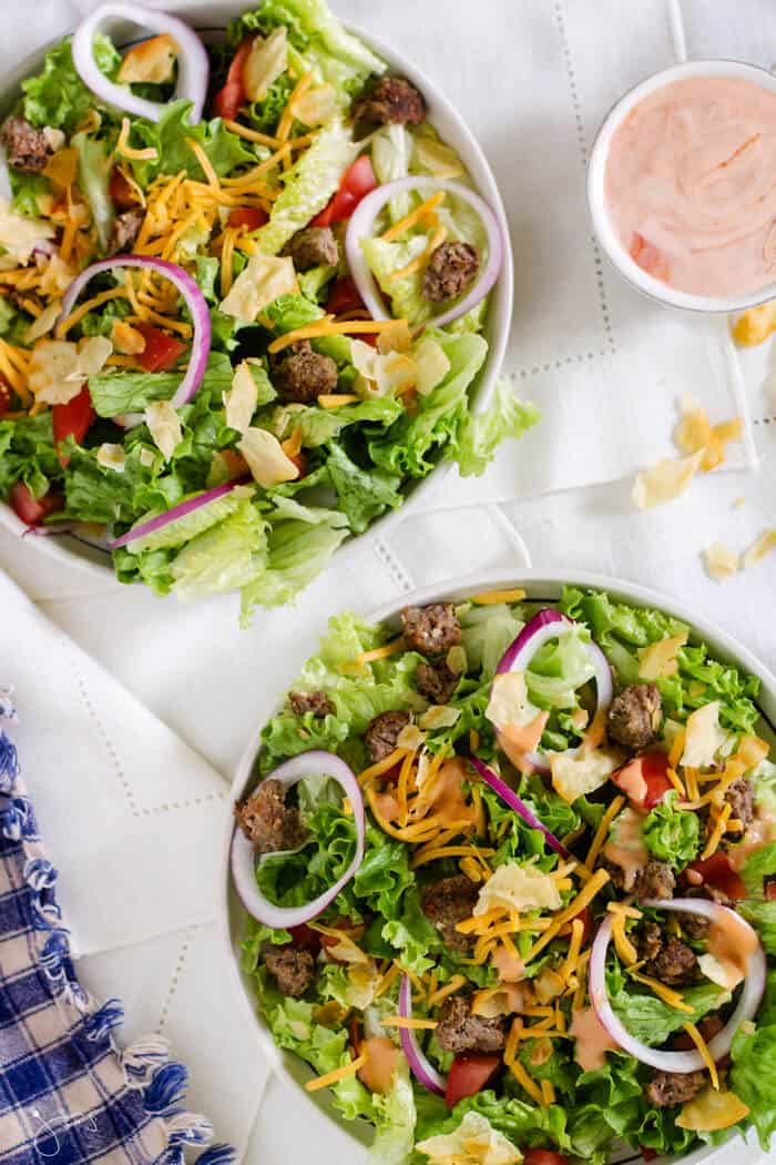 Image of two bowls of salad with broken up beef patty.