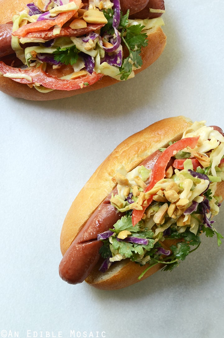 Image of two hot dogs with Thai slaw and nuts.