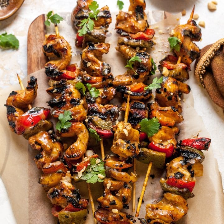 Image of skewers of chicken kebabs covered in satay sauce.