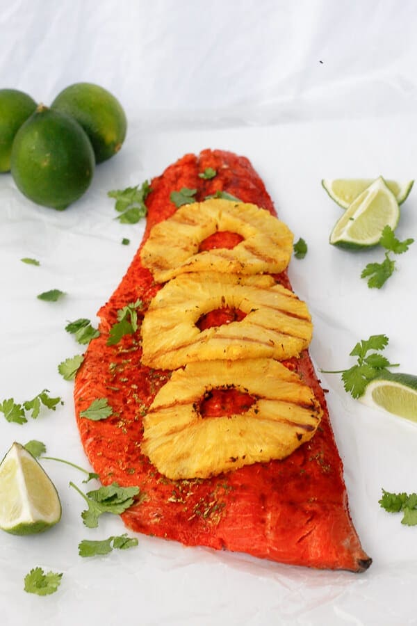 Image of grilled side of salmon with three rings of pineapple.