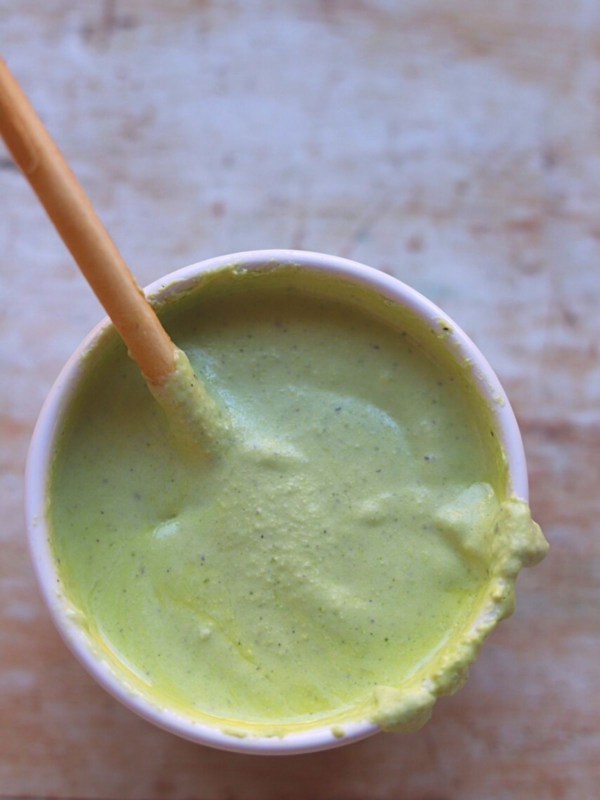 whipped feta dressing in small white bowl with breadstick