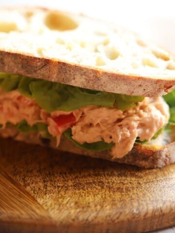 Sandwich with tuna mix and lettuce on a wooden board..