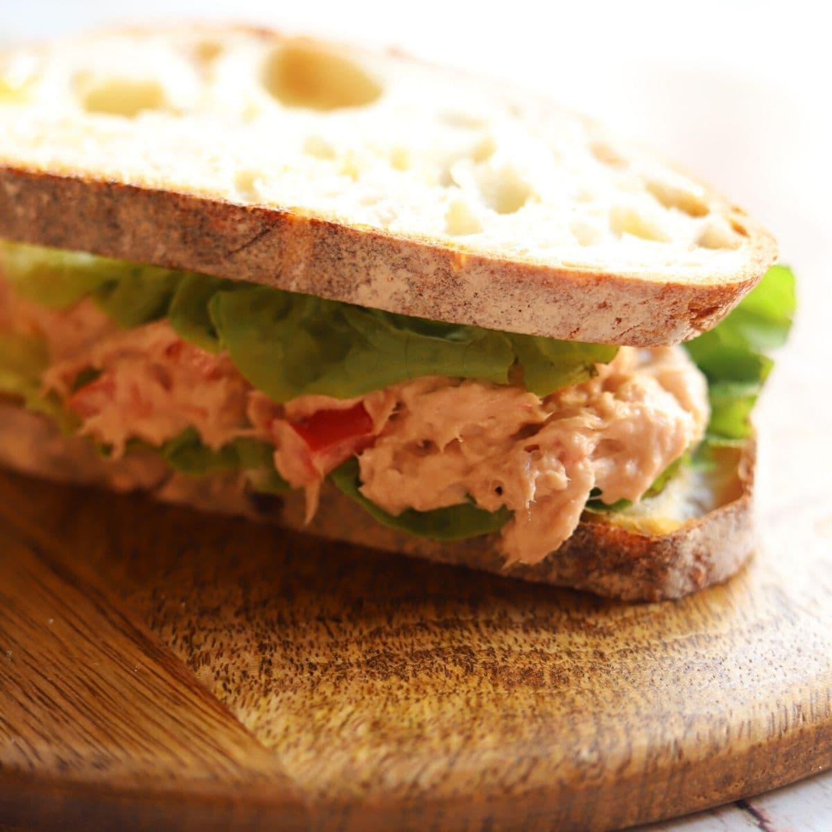 Sourdough bread sandwich filled with tuna mix and lettuce.