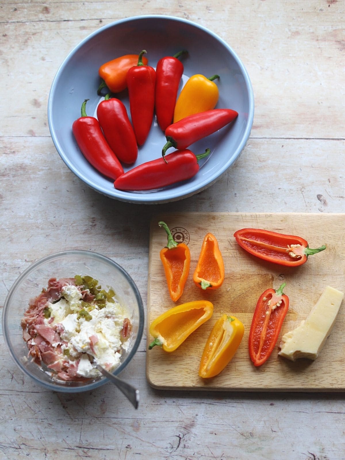 Image showing filling mix and halved peppers and cheese.