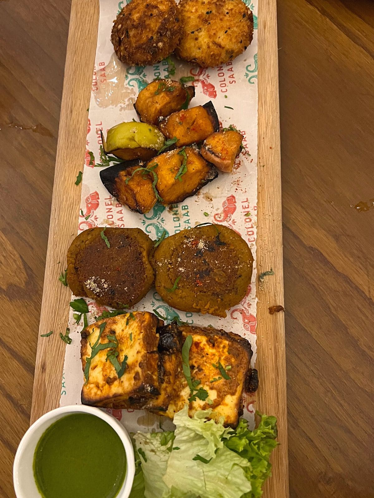 Vegetarian finger foods on wooden platter.