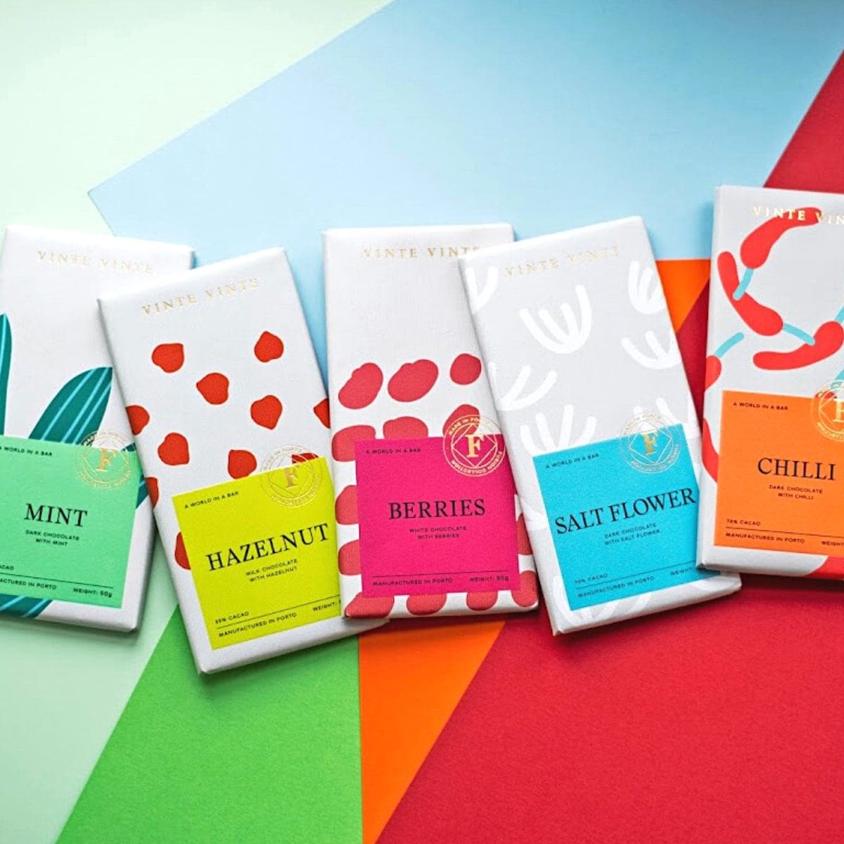 Five colourfully packaged Vinte Vinte chocolate bars.