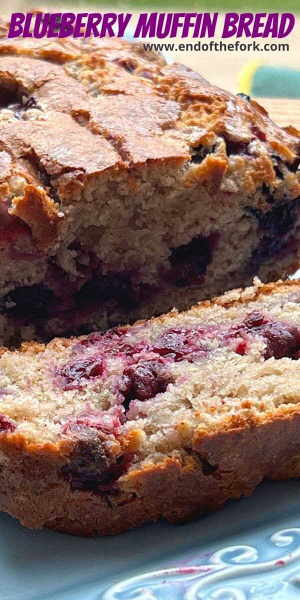 Pin image of blueberry muffin loaf on blue plate.
