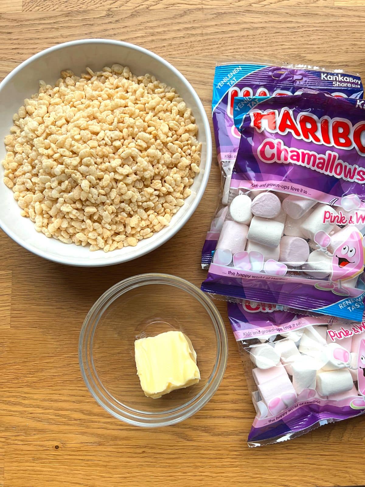 Ingredients for rice krispies on a wooden counter.