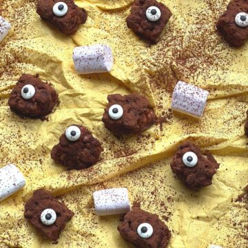 Close up of rice krispie monsters with marshmallows on yellow tissue.