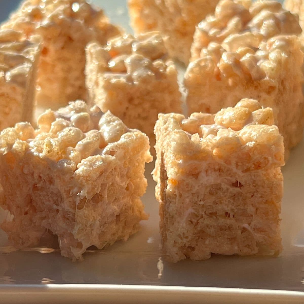 Small rice krispie squares on a plate.
