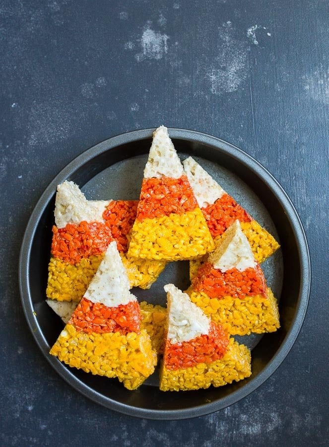 Eight wedges of rice krispie treats coloured and cut like candy corn.