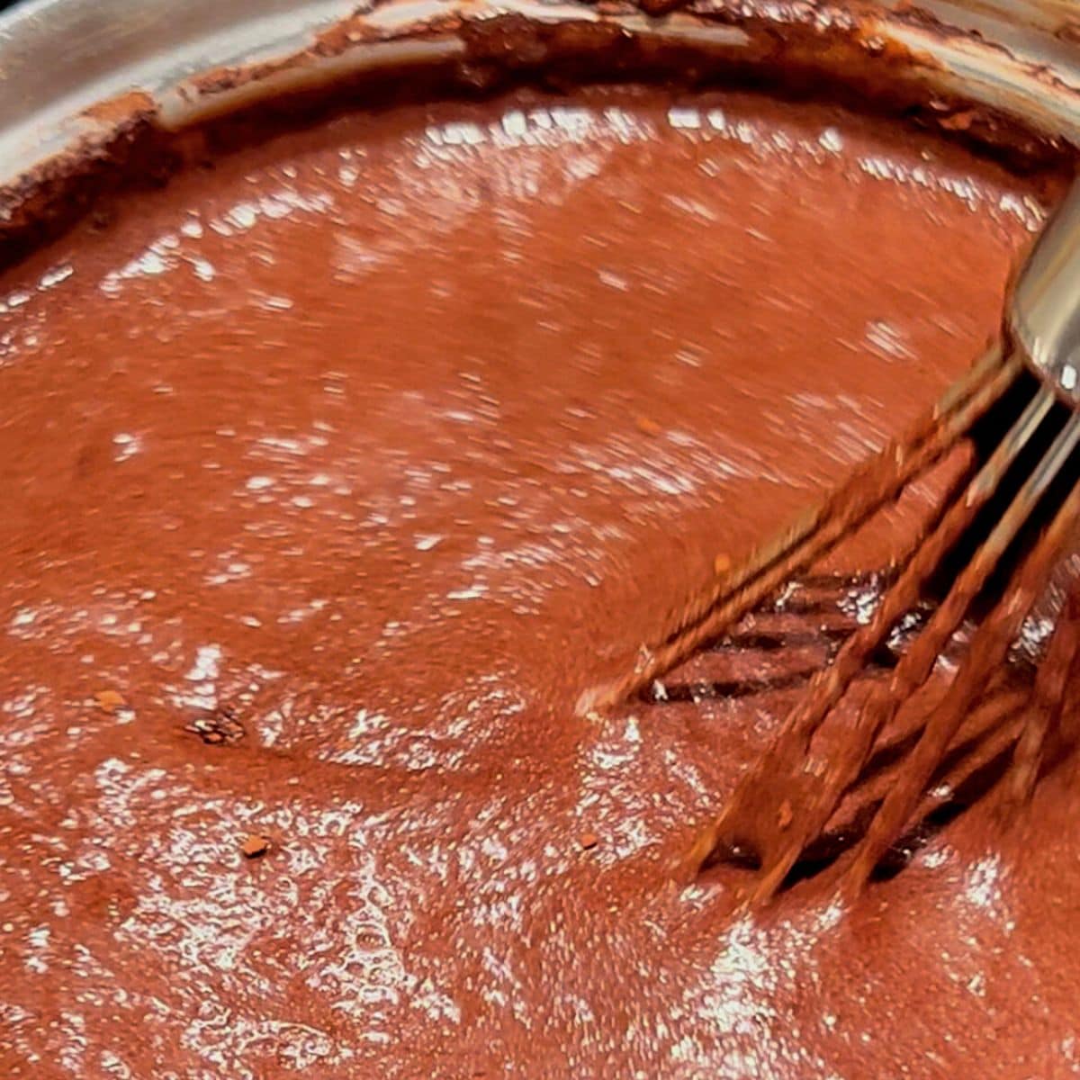 Stirring chocolate mixture in small saucepan.