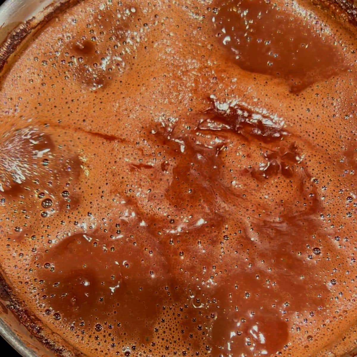 Chocolate mixture starting to boil in saucepan.