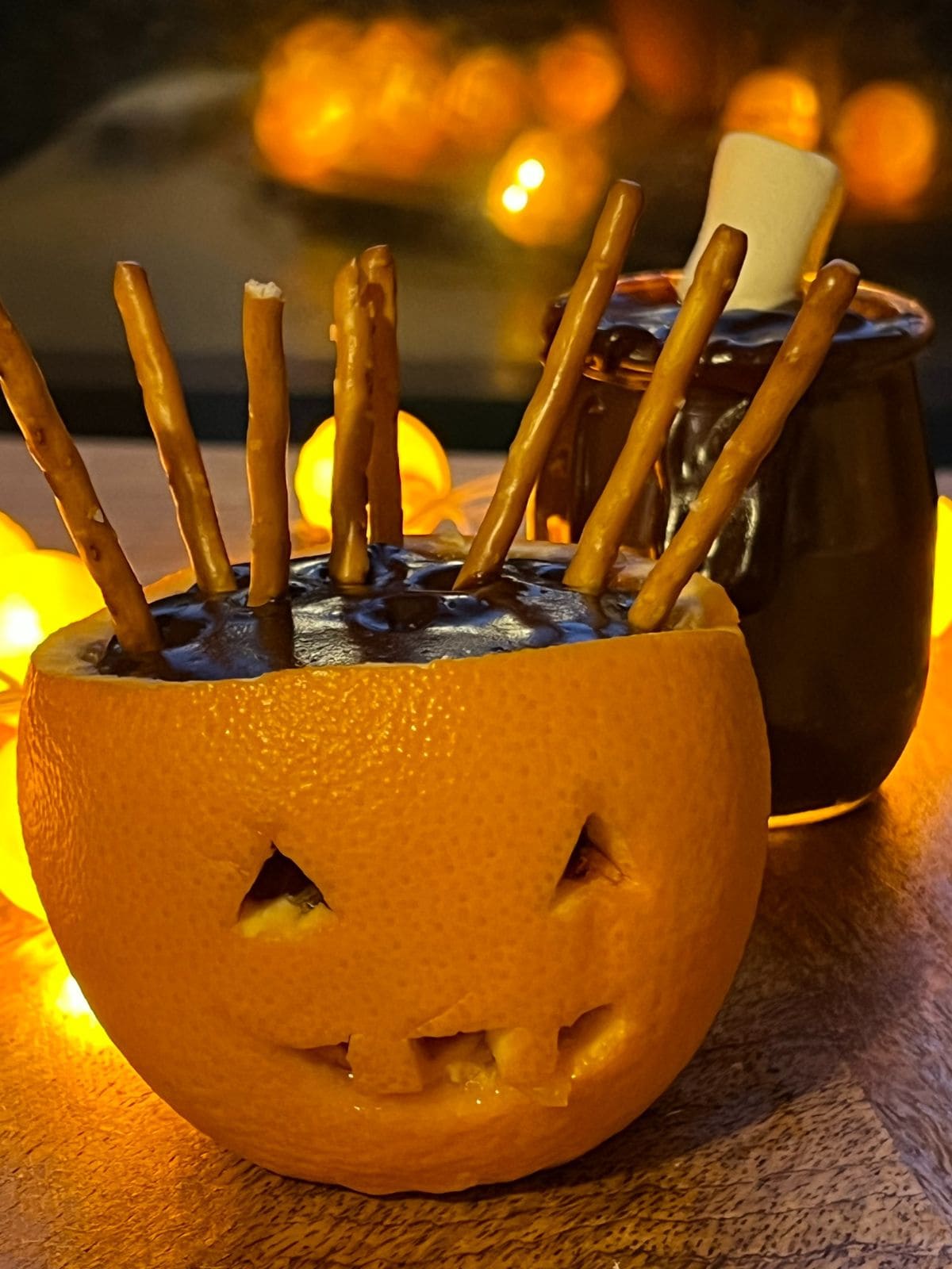 Orange jack o lantern filled with chocolate pudding.