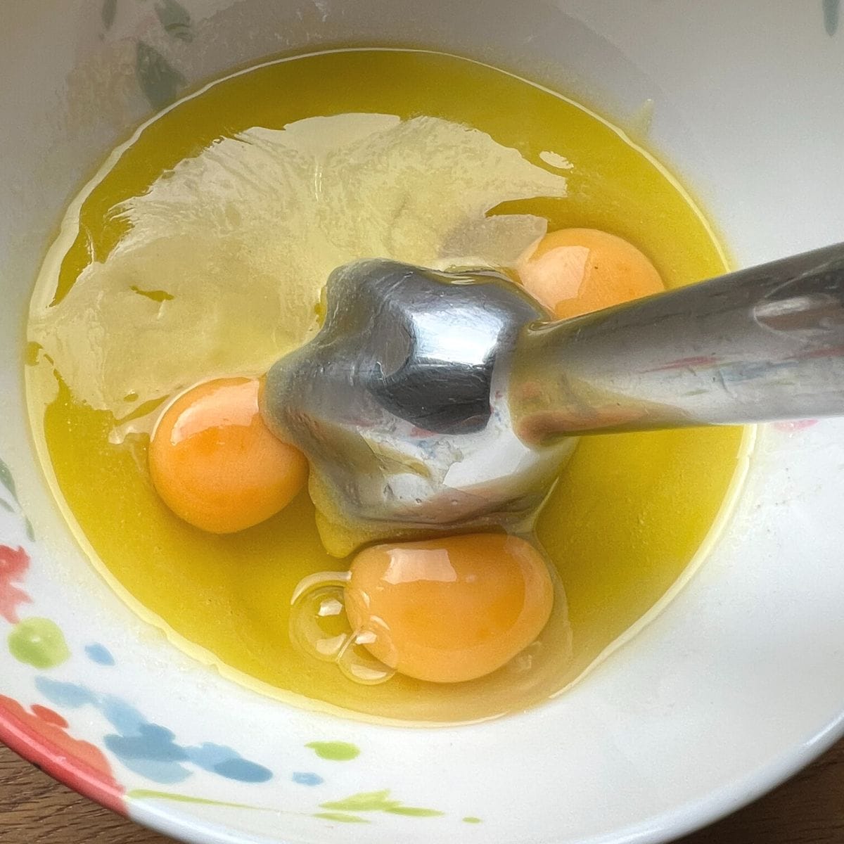 Blending eggs with hand blender.