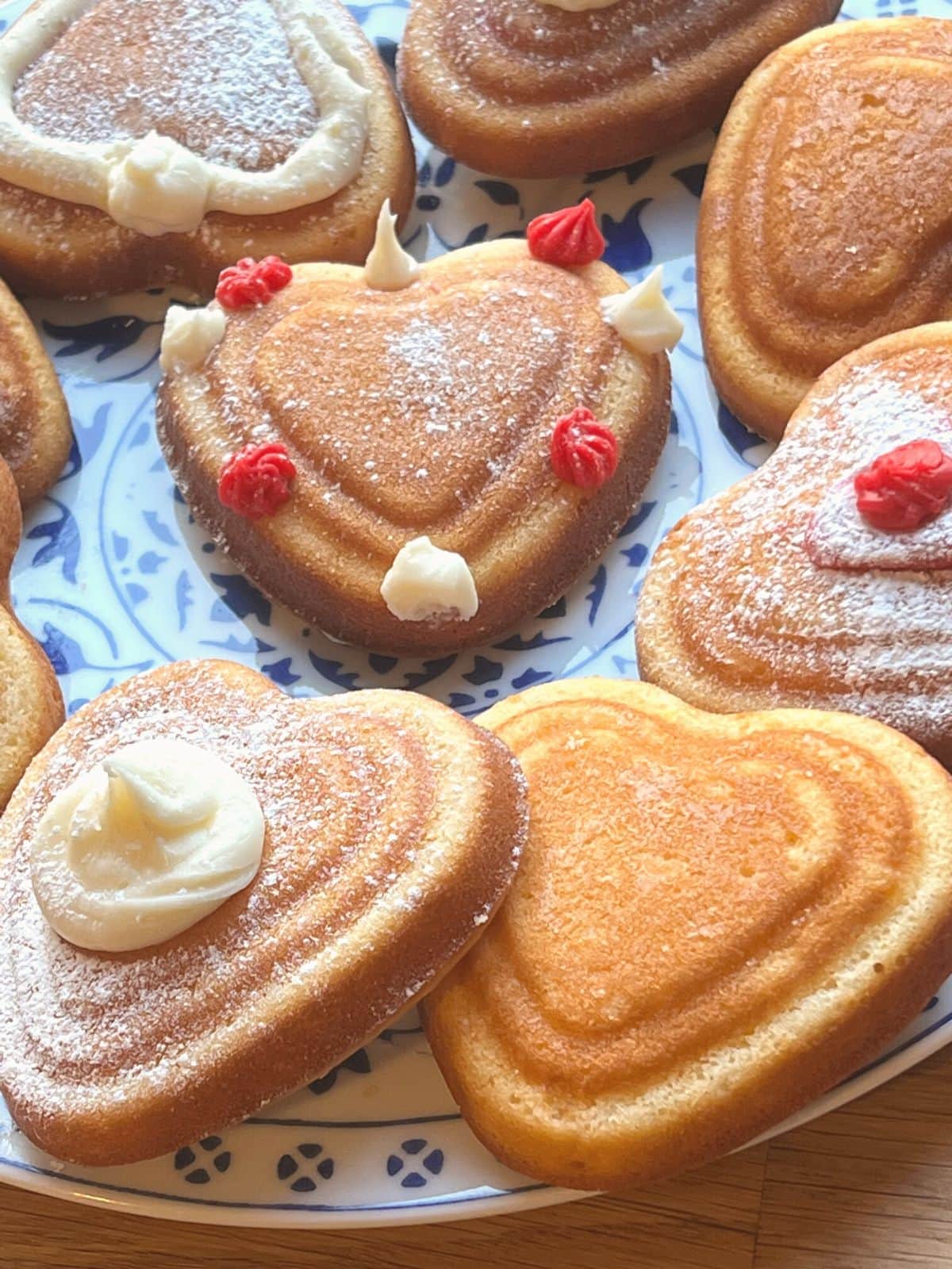 Mini heart cakes on a painted plate.