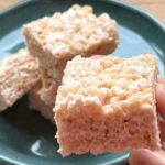 Rice krispie treats on a teal plate.