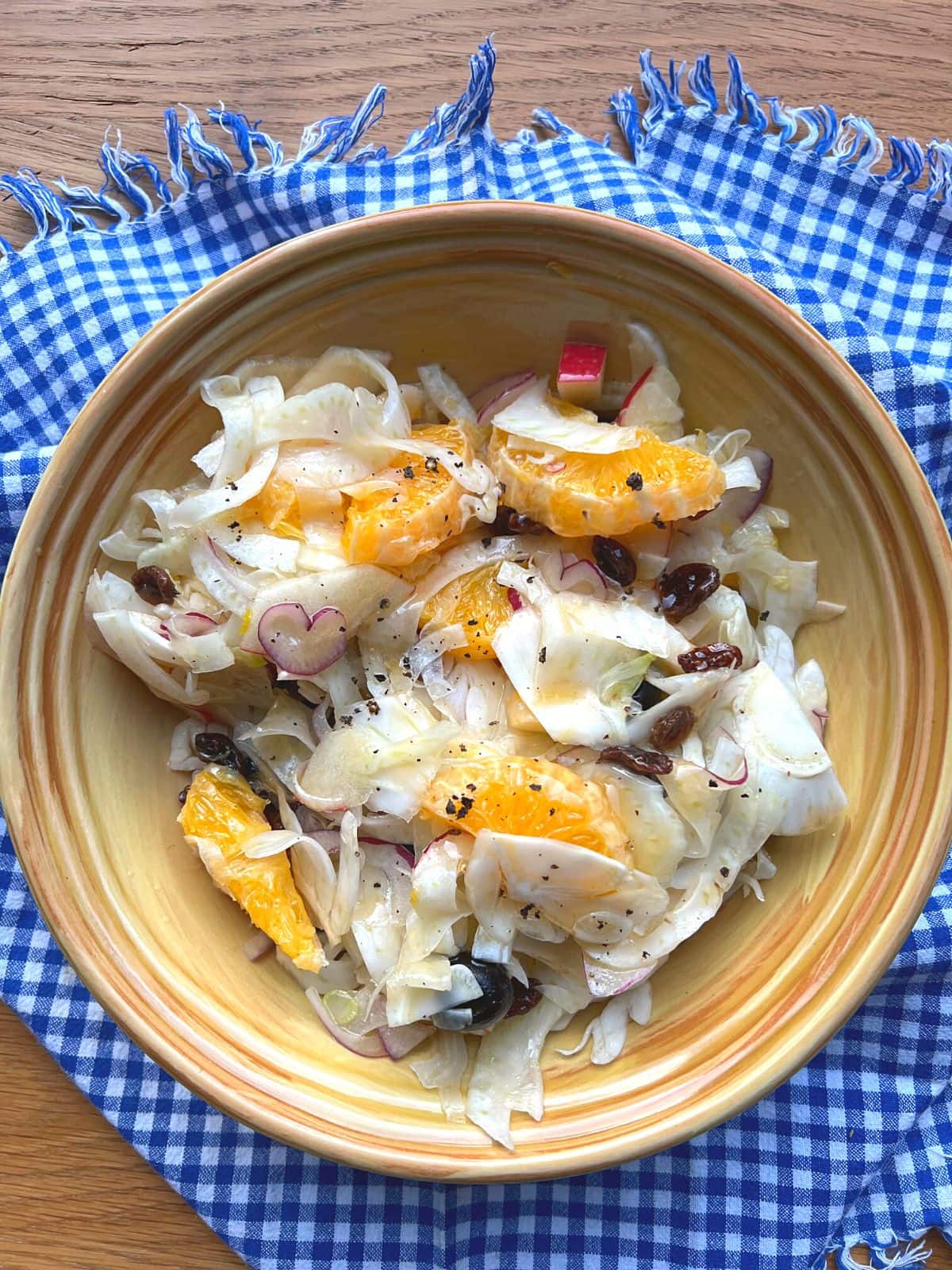 Sicilian style fennel salad in yellow bowl.