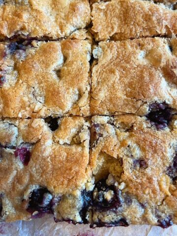 Blueberry blondies on baking paper.