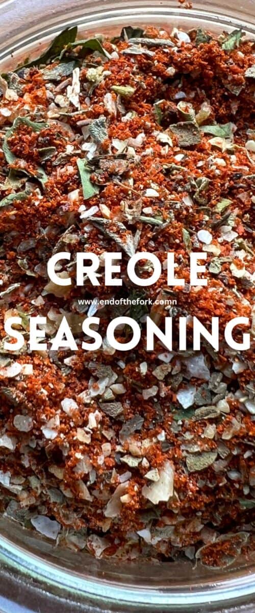 Pin image of Creole seasoning in green bowl.
