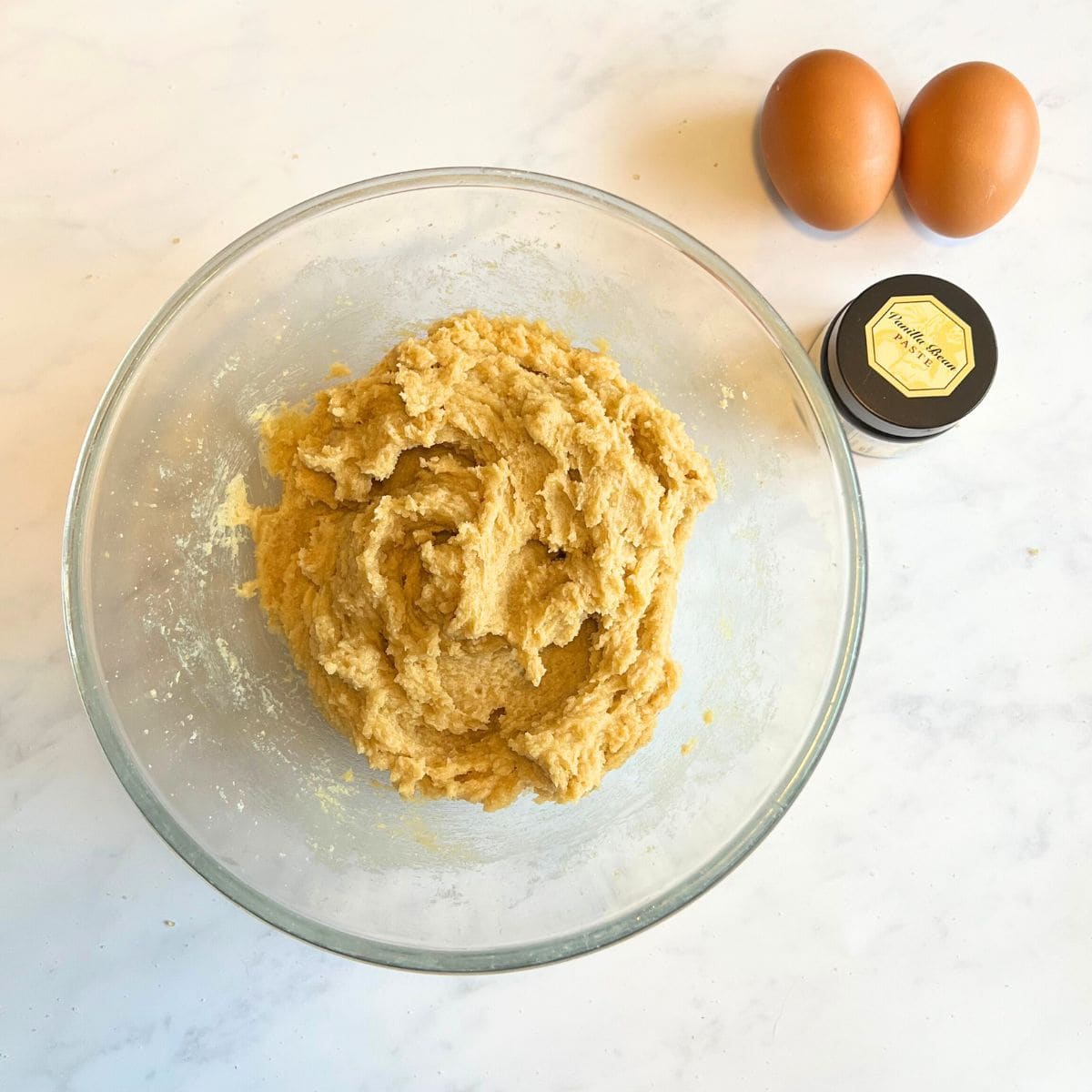 Butter blended with both  sugars in glass bowl.