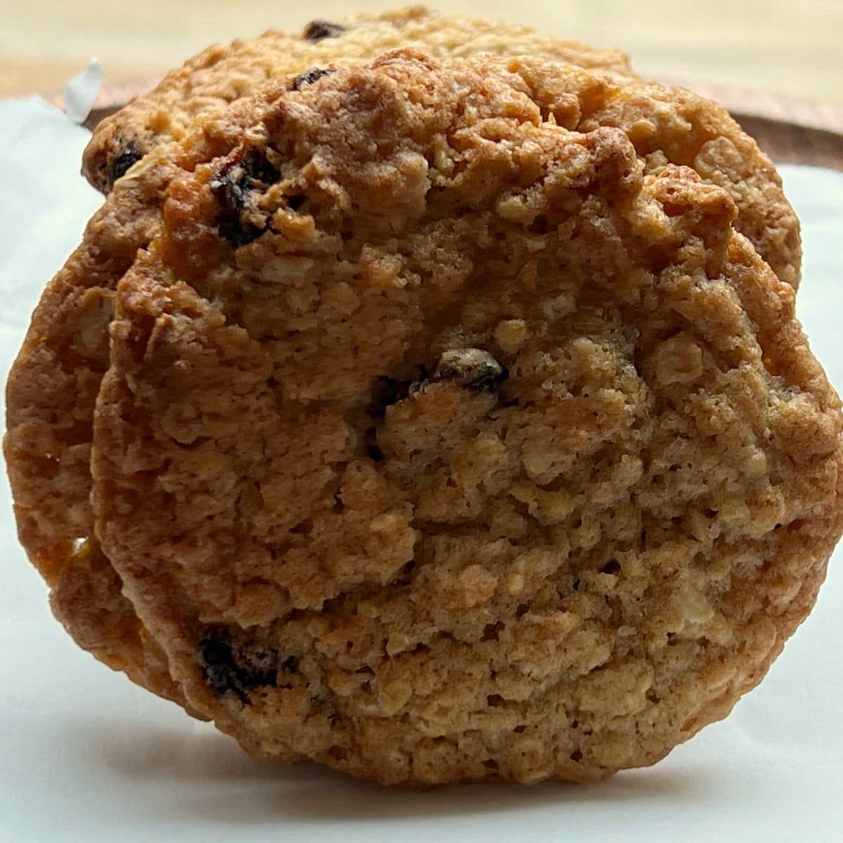 Whole oatmeal raisin cookie on its side.