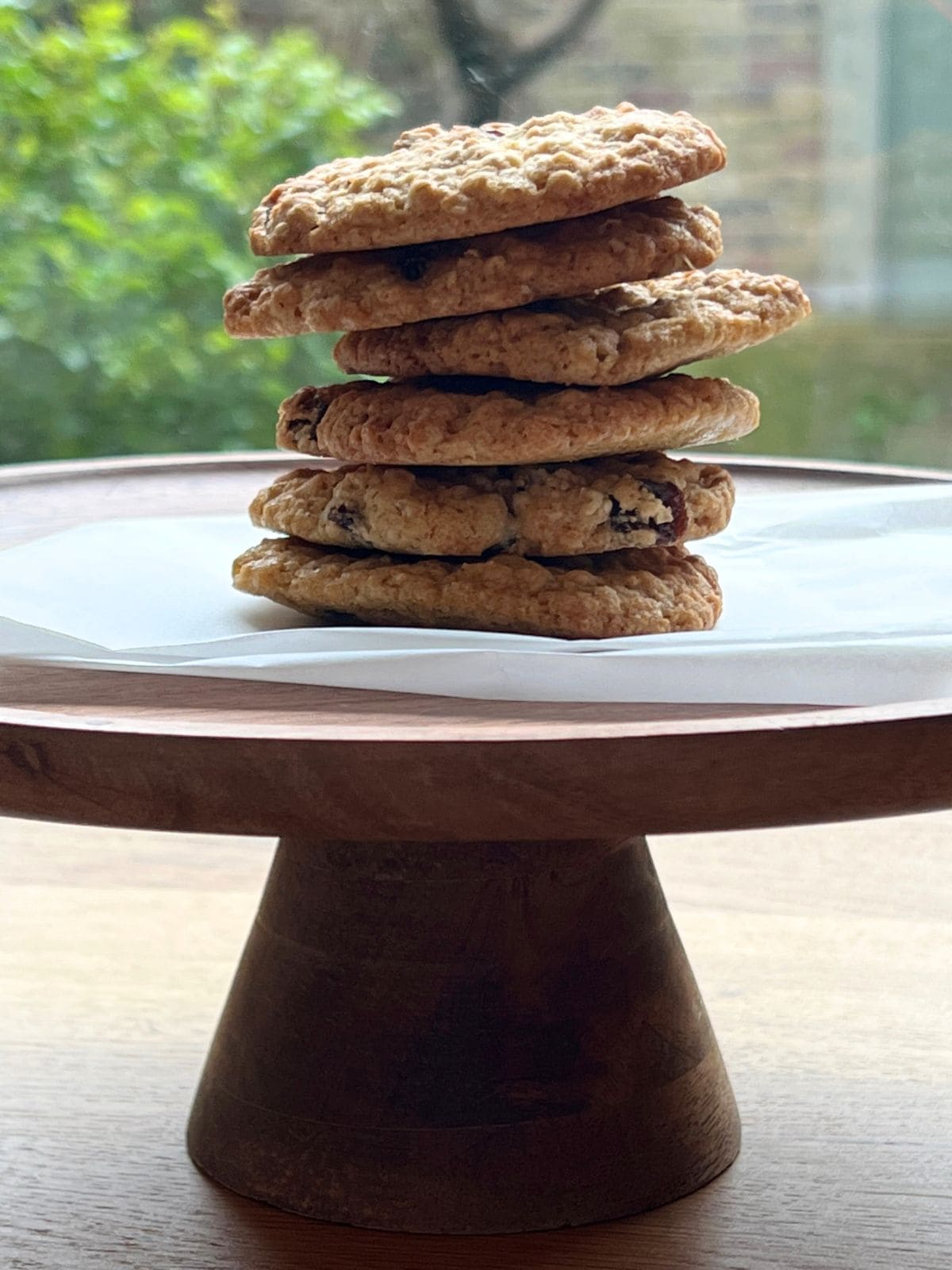 Stack of cookies on wooden stand.