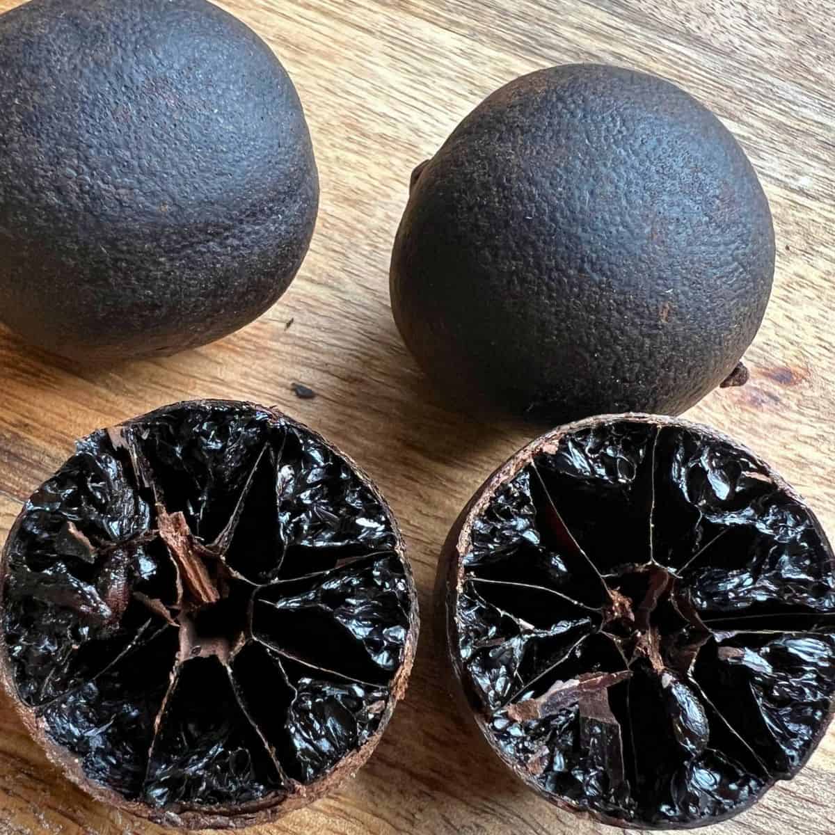 Dried black lime cut in half showing interior.