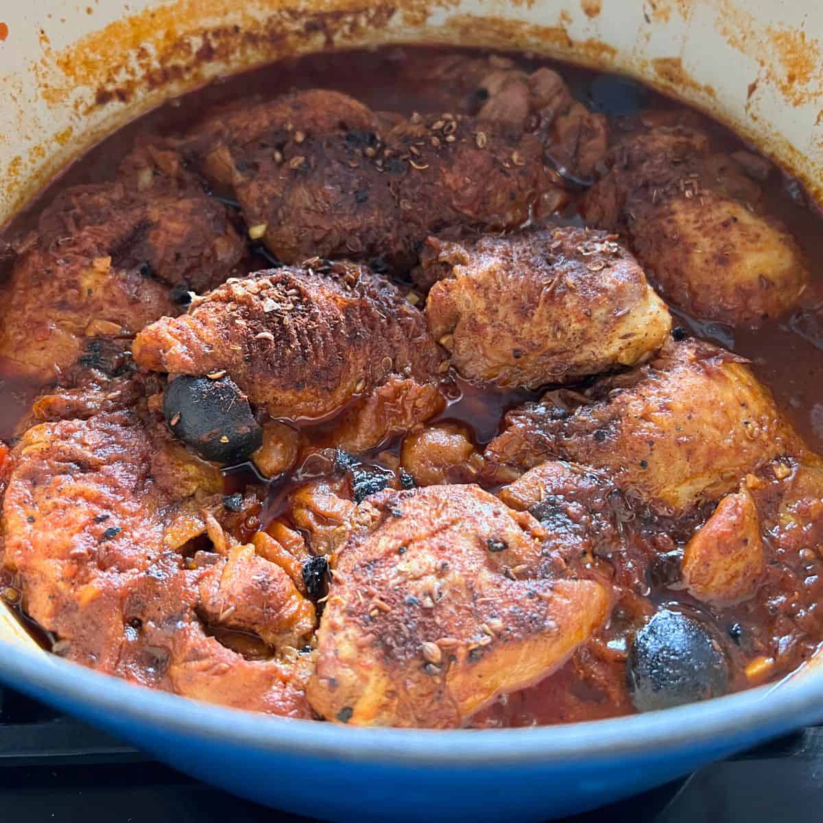 Cooked chicken in machboos sauce with dried lime.