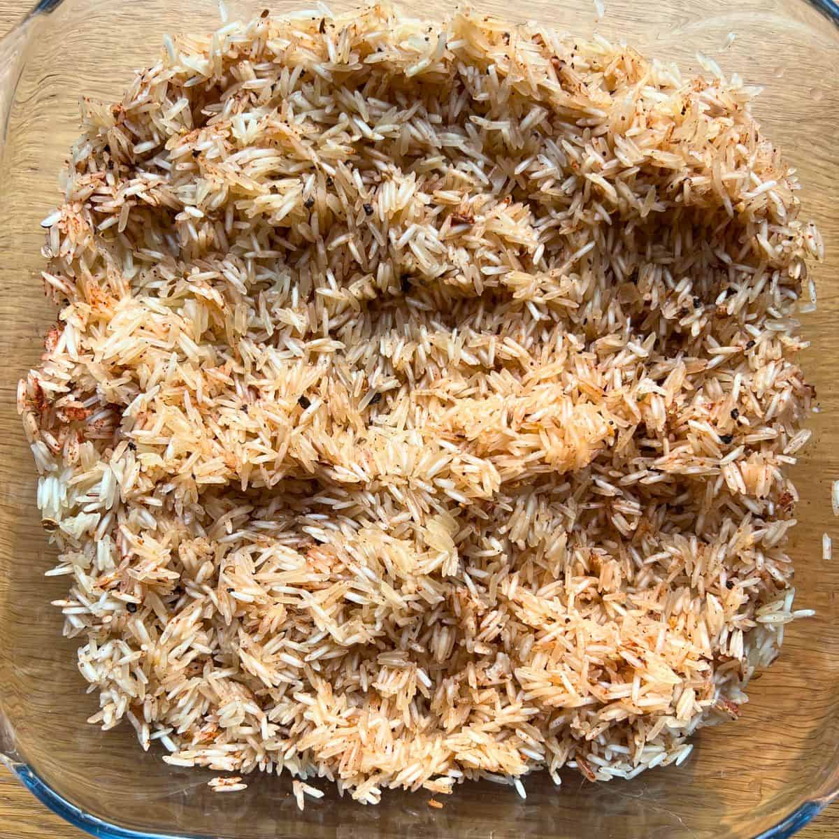 Seasoned raw rice in a glass container.