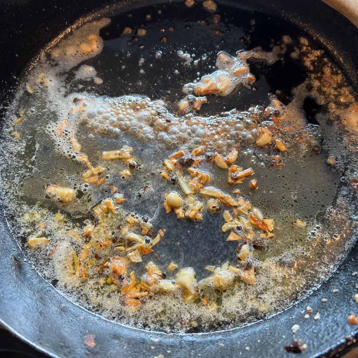 Sautéeing garlic in medium skillet.