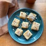 Barfi squares on a small green plate.