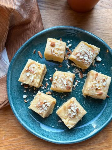 Barfi squares on a small green plate.