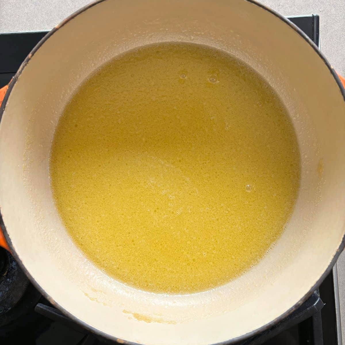 View of milk added to mixture in pan.