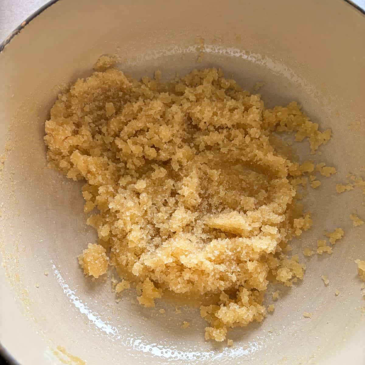 Sugar and salt mixed with ghee in pan.