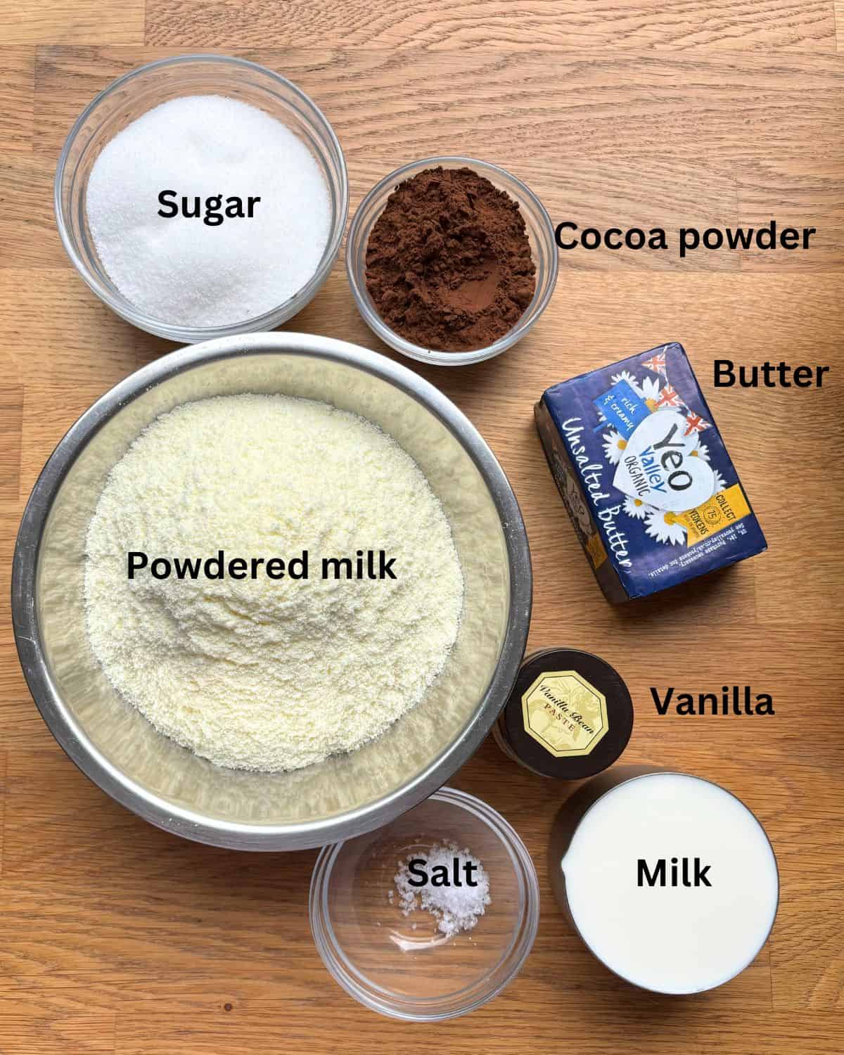 Ingredients on wooden counter for easy chocolate fudge.